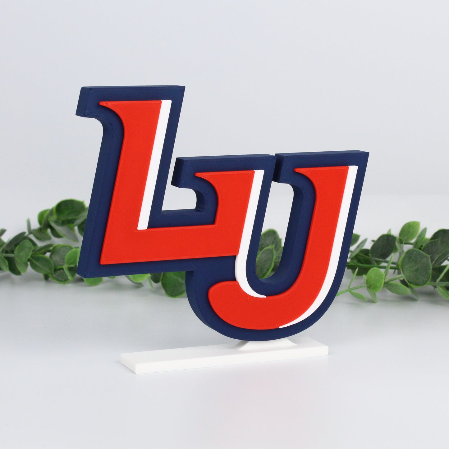 Liberty University decoration with ivy behind it; angled right.