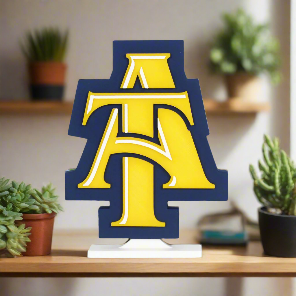 North Carolina A&T State University decoration on a wooden shelf with succulents.