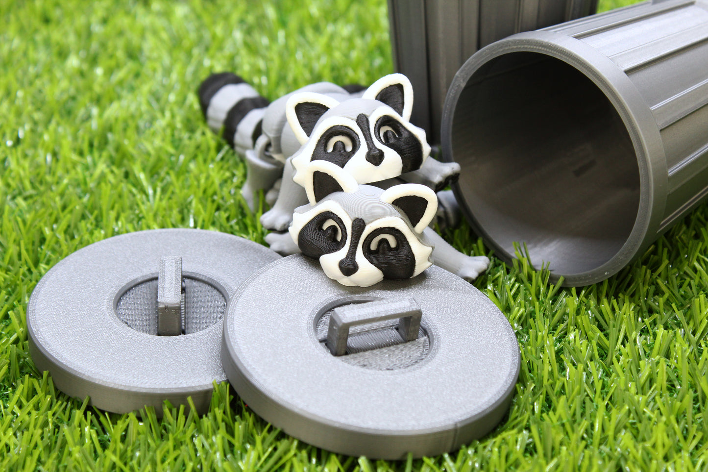 Raccoons outside of trashcans on grass.