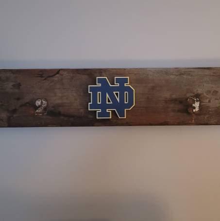 Review photo of the University of Notre Dame decoration mounted on a coat rack.