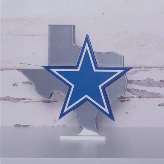 Dallas Cowboys decoration in front of a shiplap wall, rotating.