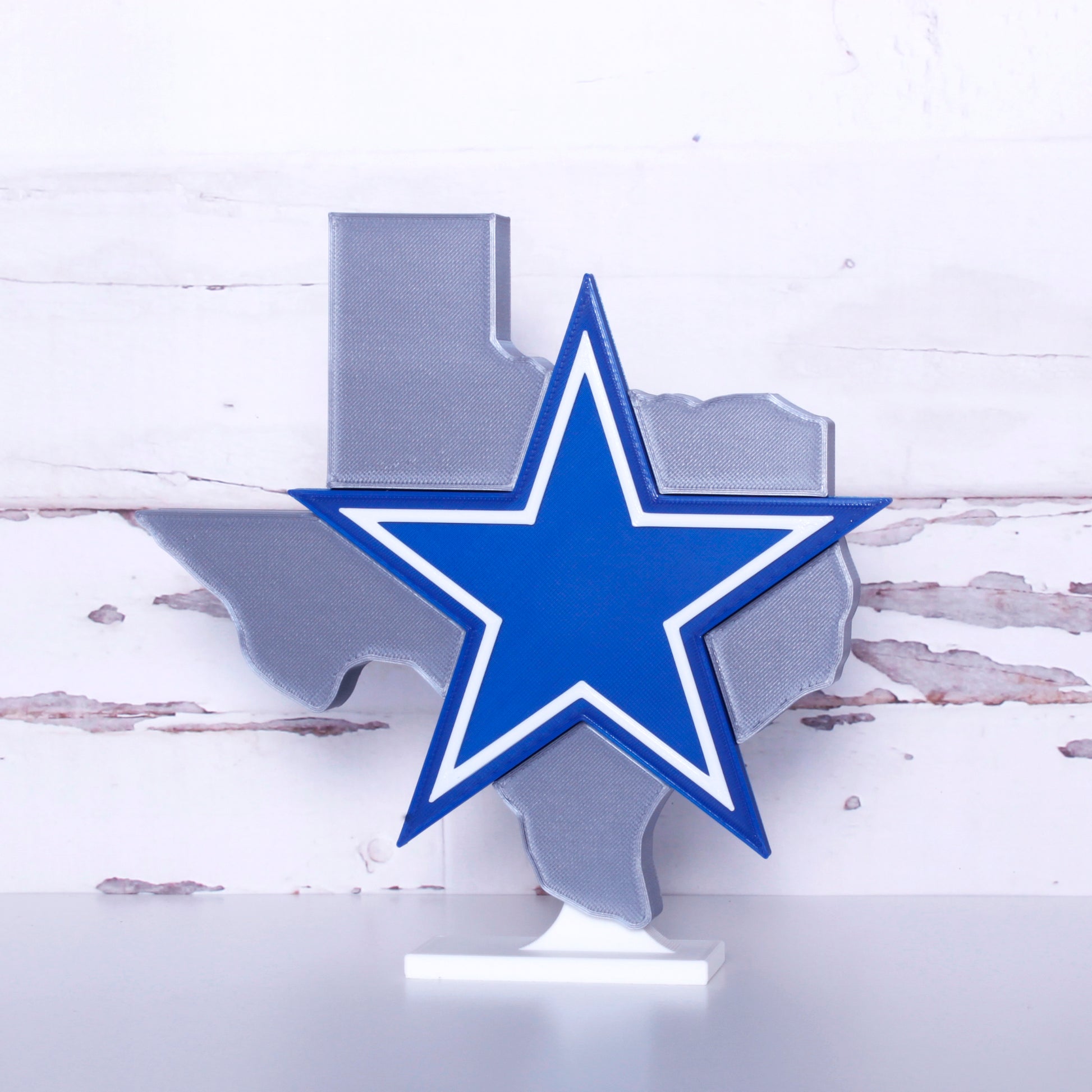 Dallas Cowboys decoration in front of a shiplap wall.