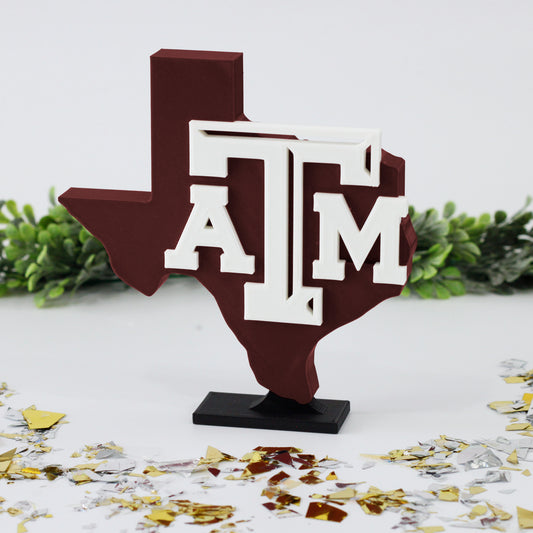 University of Texas A&M decoration surrounded with glitter with ivy behind it.