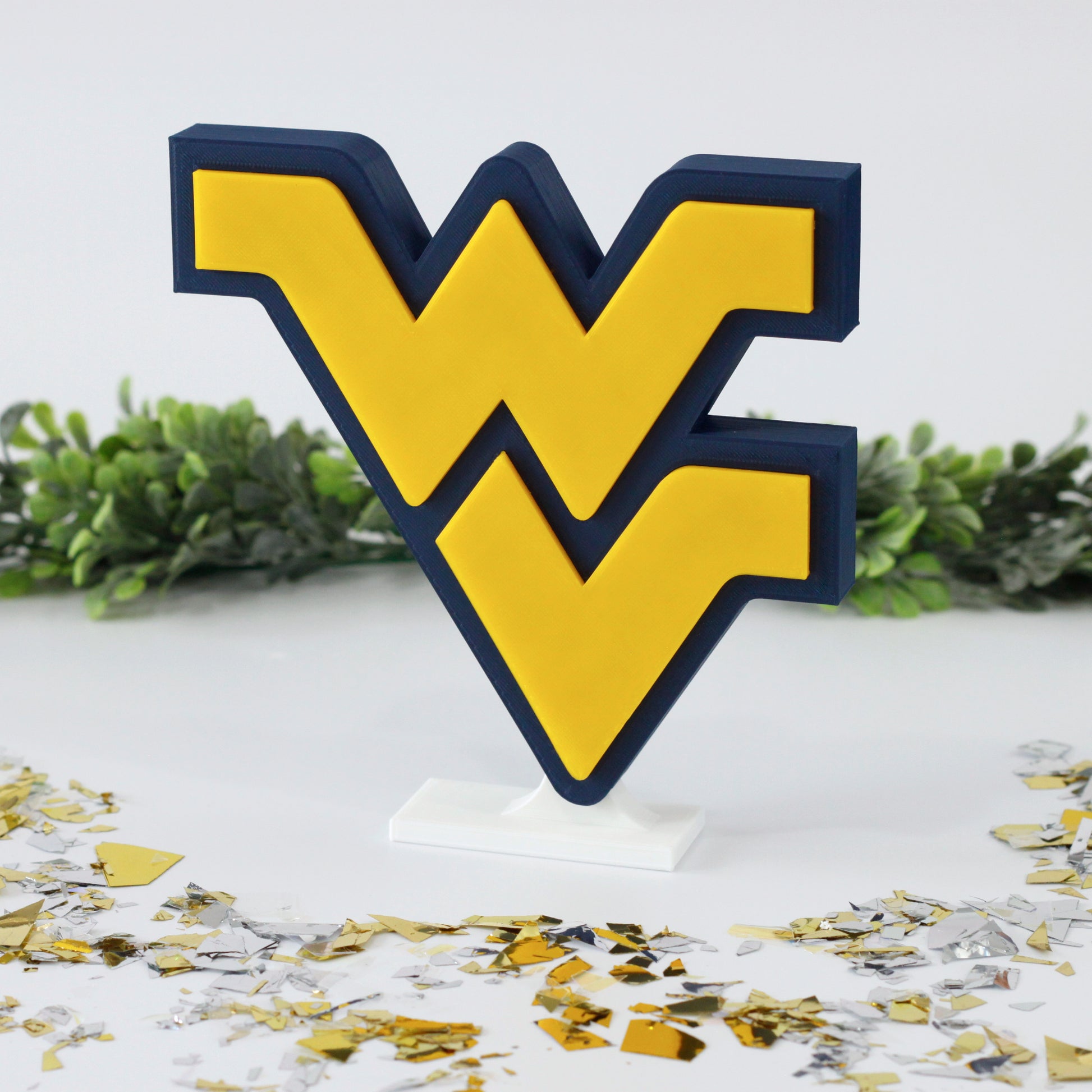 West Virginia University decoration surrounded by confetti and ivy.